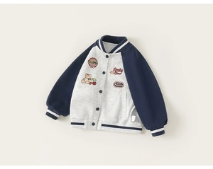 Detail view of navy blue varsity jacket with cartoon patches and Lucky Bear embroidery