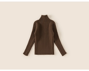 Close-up of dark brown ribbed knit fabric texture on a child turtleneck sweater