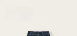 Detailed view of dark blue denim kids cargo pants with elastic waistband and neat stitching