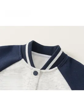Close-up of kids varsity jacket with navy sleeves and Allforkids letter embroidery