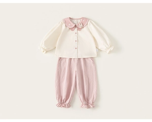 Detail of cream long-sleeve shirt with pink Peter Pan collar and matching joggers