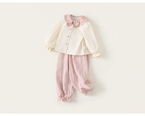 Detail view of cotton toddler girl set featuring floral embroidery and Peter Pan collar