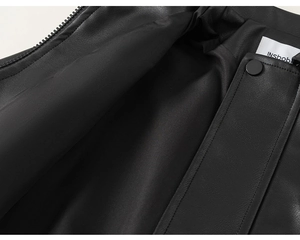 Detail of black leather jacket showing smooth lining, metal zipper and snap button