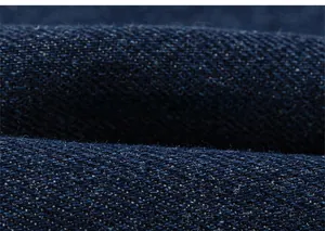 Macro shot of dark blue denim twill fabric showing detailed texture and soft cotton fibers