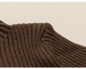 Detail of dark brown ribbed knit texture and smooth shoulder seam on children sweater
