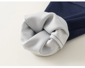 Detailed close-up of double-layer knit fabric with reinforced stitching and soft grey lining