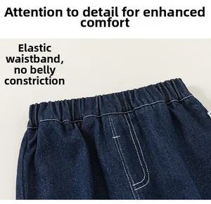 Detail of boys dark blue denim joggers showing the elastic waistband and white stitching