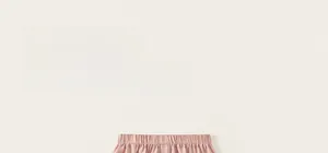 Close-up of the comfortable elastic waistband on soft pink cotton trousers for girls