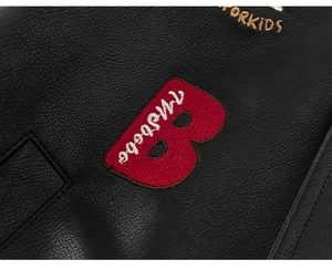 Close-up of premium black leather jacket with embroidered B patch and FORKIDS lettering