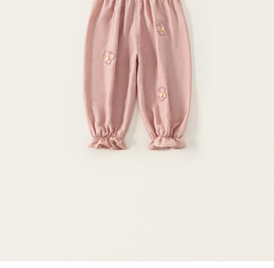 Detail of pink toddler pants featuring ruffled cuffs and delicate butterfly embroidery patches