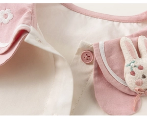 Detail of pink Peter Pan collar with delicate floral embroidery and rabbit applique