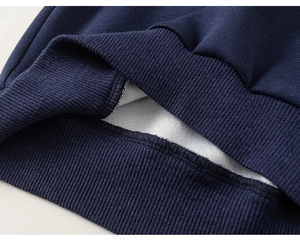 Detailed macro view of navy blue ribbed cuffs with warm grey fleece lining for boys' set