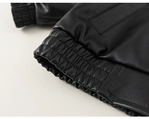 Detail of elastic ribbed cuffs and matte lychee texture on children leather jacket