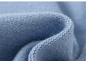 Close-up of sky blue knit fabric texture showing soft pleats and fine ribbed pattern