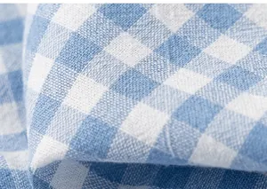 Macro detail of breathable blue and white gingham cotton fabric texture for boys' shirts