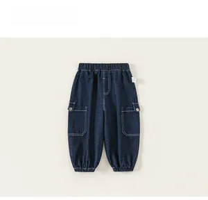 Detail of dark blue boys' cargo denim pants with elastic waist and side pockets