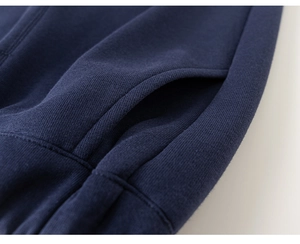 Detail of reinforced pocket stitching on navy blue knit cotton kids tracksuit set