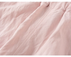 Detail of pink cotton fabric with high-quality double-needle stitching and soft texture