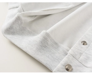 Detail of girls' baseball jacket with fleece lining, snap buttons and ribbed hem