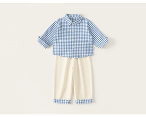 Detail of blue gingham shirt and beige trousers with matching plaid cuffed hems