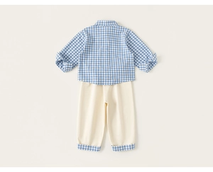Detailed flat lay of boys' blue gingham shirt and beige trousers with matching plaid cuffs