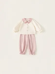 Girls' two-piece set featuring cream Peter Pan collar shirt and pink ruffled hem pants