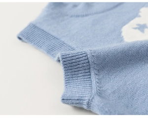 Close-up of rib-knit neck and blue star patterns on children knit vest sweater