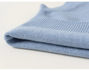Close-up of light blue knit fabric showing professional ribbed cuffs and soft texture