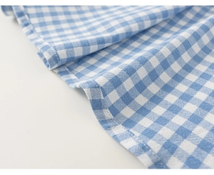 Macro shot of blue and white gingham fabric showing clean stitching and high textile quality