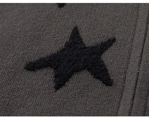 Macro detail of knit fabric texture with soft black star flocking on a dark grey base