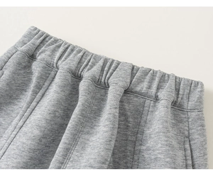 Détail du tissu en maille gris clair chiné avec une large taille élastique souple