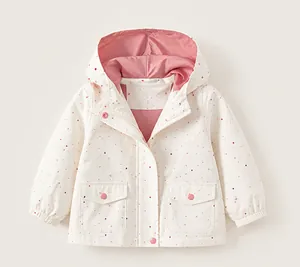 Detail of girls' polka dot outdoor windbreaker jacket featuring a soft pink inner lining