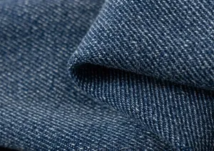 Vista macro della trama del tessuto denim blu di alta qualità e del motivo a saia