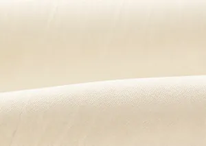 Close-up of soft cream-colored windbreaker fabric texture with smooth plain weave details