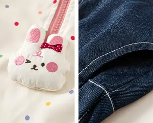Detail of bunny embroidery with pink bow and denim pocket with white stitching