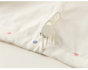 Macro detail of toddler girl windbreaker with colorful polka dots and elastic drawstring