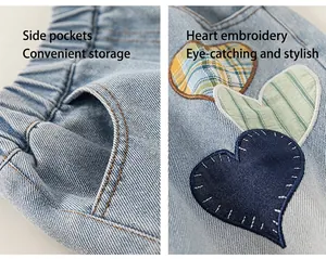Detail of kids heart-shaped embroidery and elastic waistband on light blue denim pants