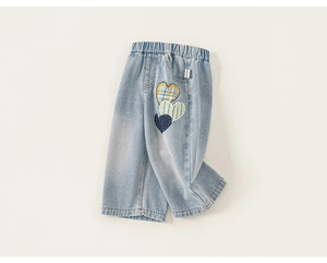 Detail showing elastic waistband and triple heart embroidery on denim pants