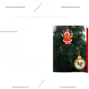 Close-up of PVC Christmas hanging ornament with Santa Claus motif on a tree branch