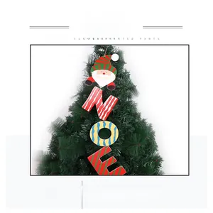 Detailed view of NOEL hanging wooden sign with Santa Claus on a green Christmas tree