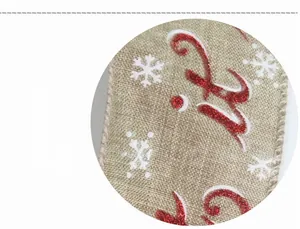 Close-up detail of imitation linen Christmas ribbon with red letters and white snowflakes