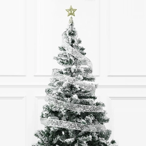 Frosted Christmas tree with white snowflake ribbons and a golden star tree topper
