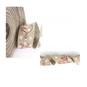 Close-up of 10m burlap Christmas ribbon with snowflake prints and red Merry lettering