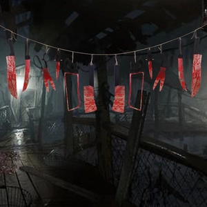 Detailed view of bloody plastic tool garland with saws and cleavers for Halloween decor