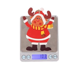 Detail shot of a 10.3g lightweight wooden reindeer ornament on a digital scale