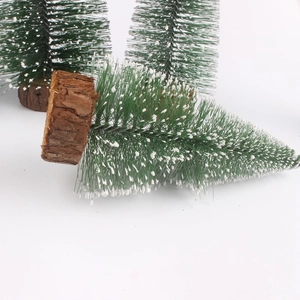 Detailed close-up of mini snow-flocked Christmas trees with natural wooden bases