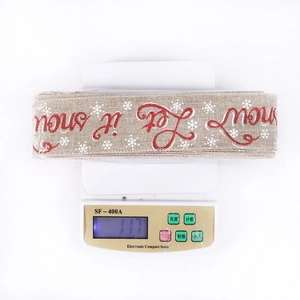 Detail view of 10m Christmas burlap ribbon with Let it Snow print and snowflake patterns