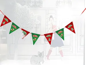 Close-up of paper Christmas bunting with Merry Christmas text and holiday character prints