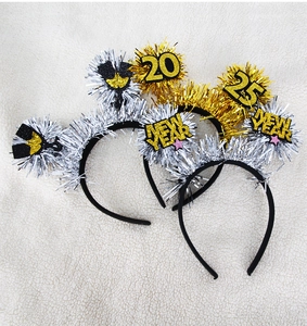Detail of 2025 New Year headbands with gold and silver glitter tinsel on white background