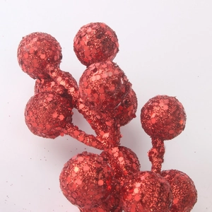 Macro detail of red glitter Christmas berries with sparkling sequin finish for festive decor